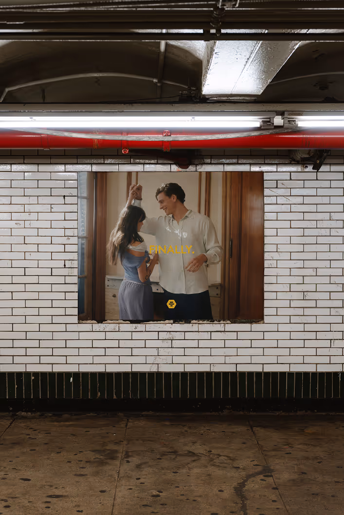 Credit: Maison Mockups. Subway wall poster of a man and woman dancing indoors with the word 'FINALLY.' in yellow text.