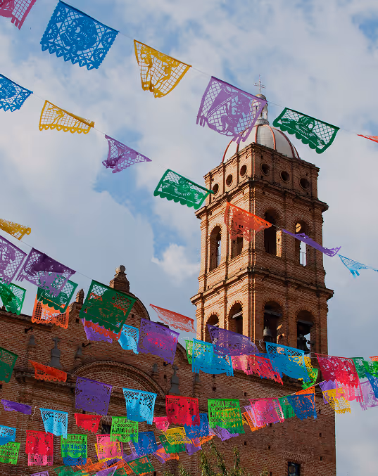 Credits: iStock Philip Stewart.
The new church in Tapalpa, Jalisco, Mexico, with colorful banners of papel picado in the foreground, left over from the Dia de Muertos celebration.