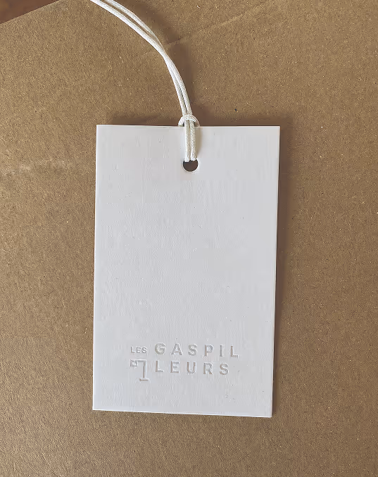 Credit Chat GPT
White Les Gaspilleurs product tag on natural paper with logo embossed